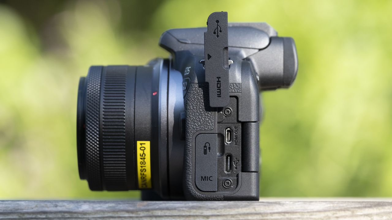 The Canon EOS R10 camera sitting on a wooden bench