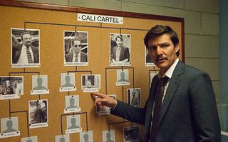 Pedro Pascal, as Javier Peña, points to an evidence board in Narcos
