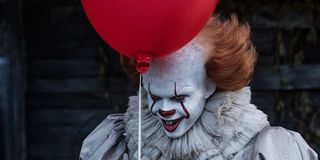IT Pennywise holding a balloon with a smile