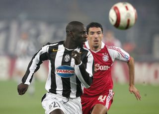 Juventus defender Lilian Thuram vies for the ball with Bayern Munich forward Roy Makaay in the Champions League in October 2004.