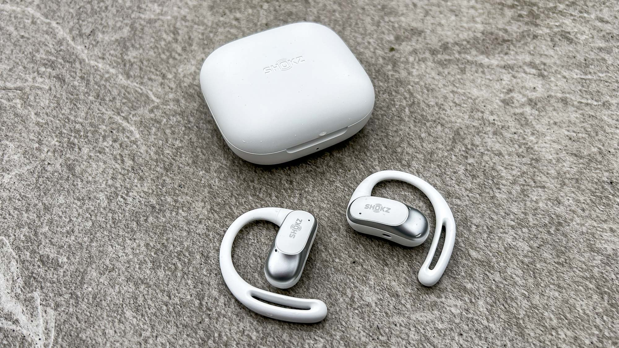 Shokz OpenFit Air next to the charging case