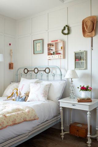 child's bed in a white panelled room