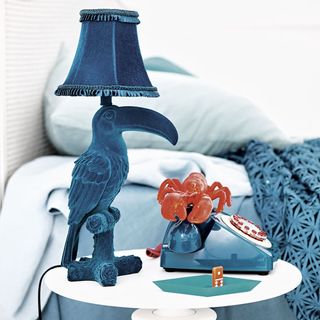 blue bird designed lamp and crab on blue telephone
