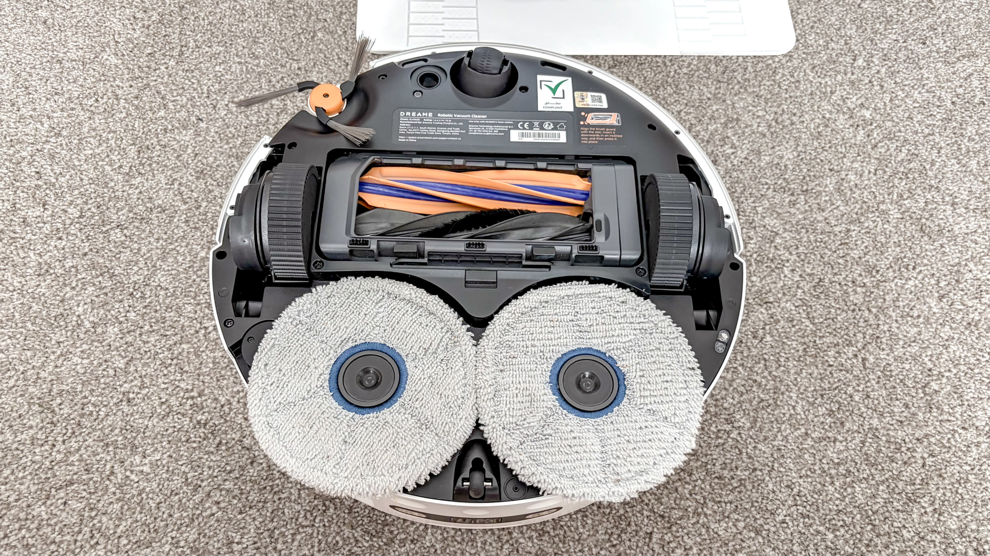 Dreame X60 Max Ultra Complete in white photographed on gray carpet.