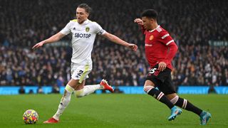 Jadon Sancho of Manchester United challenges Luke Ayling of Leeds United during a Premier League match