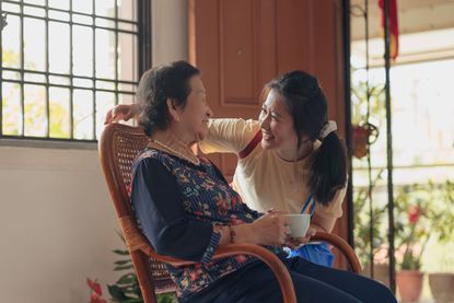 A granddaughter visits with her grandmother. 