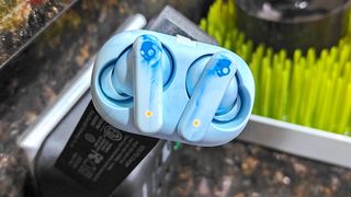 Skullcandy EcoBuds in light blue in charging case