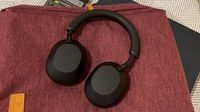 Sony WH-1000XM5 headphones in black on a red rucksack
