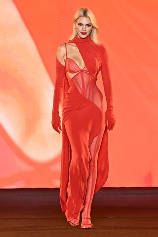 Kendall Jenner walks the runway during "Le Défilé L'Oréal Paris – Walk Your Worth" Womenswear Spring-Summer 2025 show as part of Paris Fashion Week on September 23, 2024 in Paris, France wearing a red corset dress