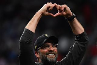 Jurgen Klopp makes a heart sign to the Liverpool fans after the Reds' Champions League final win over Tottenham in June 2019.