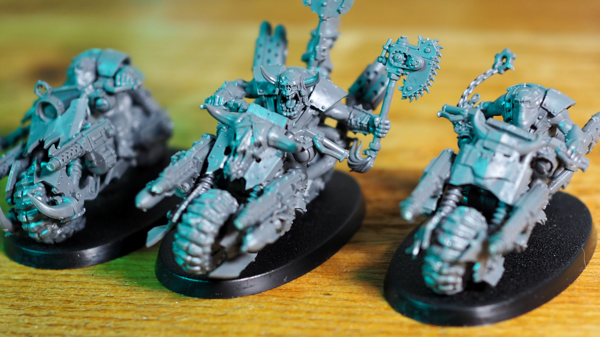 Warhammer 40K Orks Warbikers in a row, seen on a wooden table