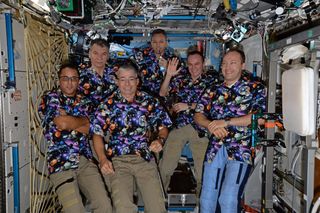 Crewmembers on the International Space Station celebrate "Aloha Friday," with space-themed Hawaiian shirts.