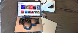 The AirPods Max resting on a MacBook Pro