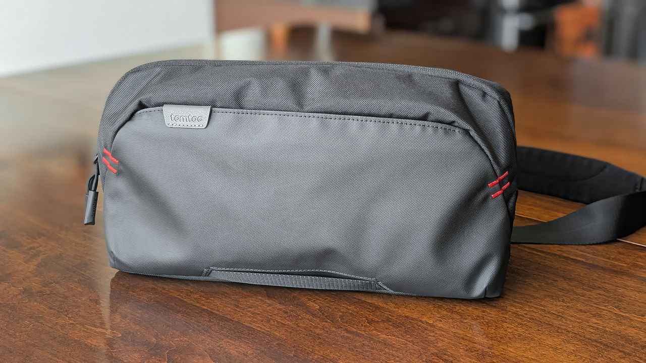 The Tomtoc Arccos G-47 Travel Bag on a wooden table.