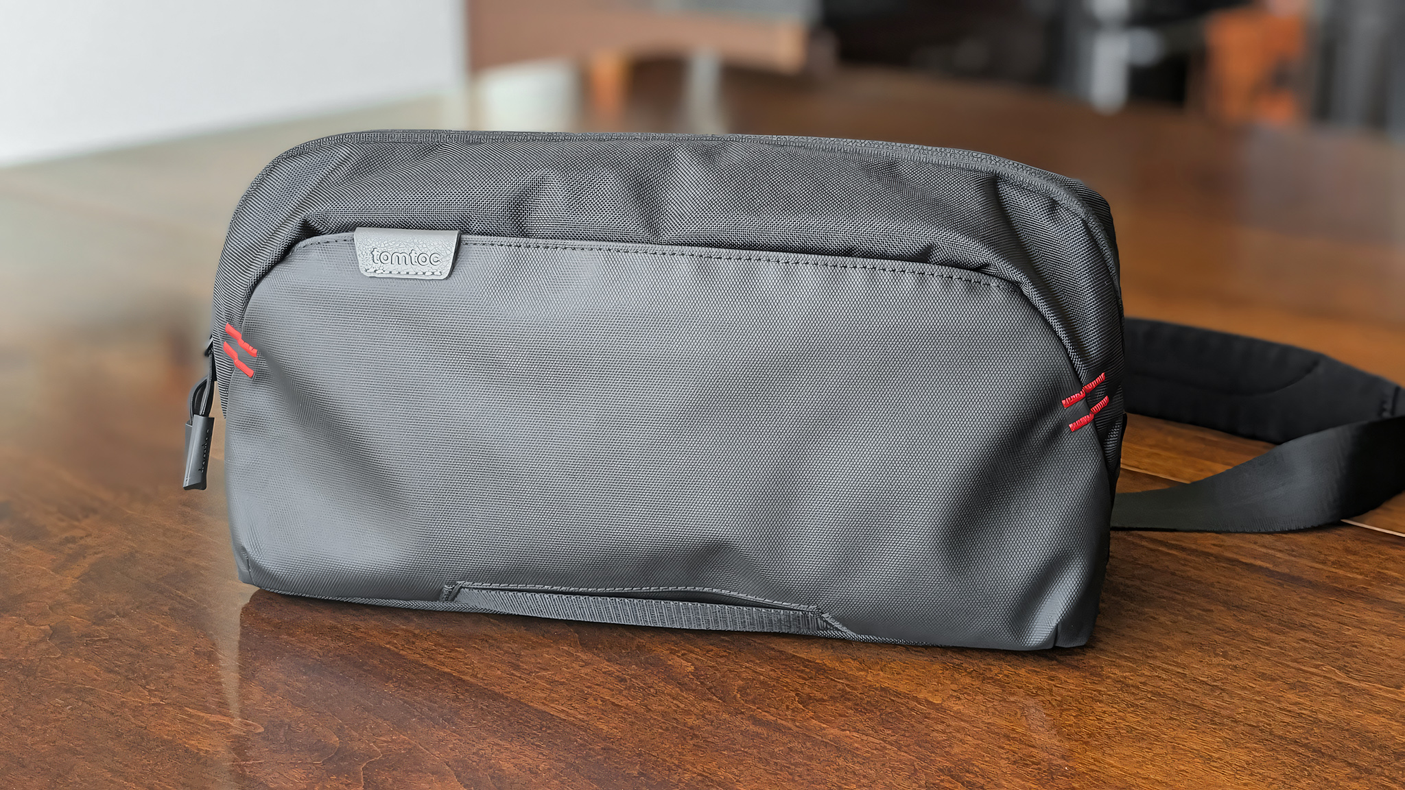 The Tomtoc Arccos G-47 Travel Bag on a wooden table.