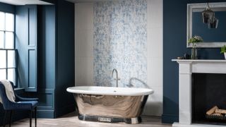 bathroom with patterned tiles and rolltop bath