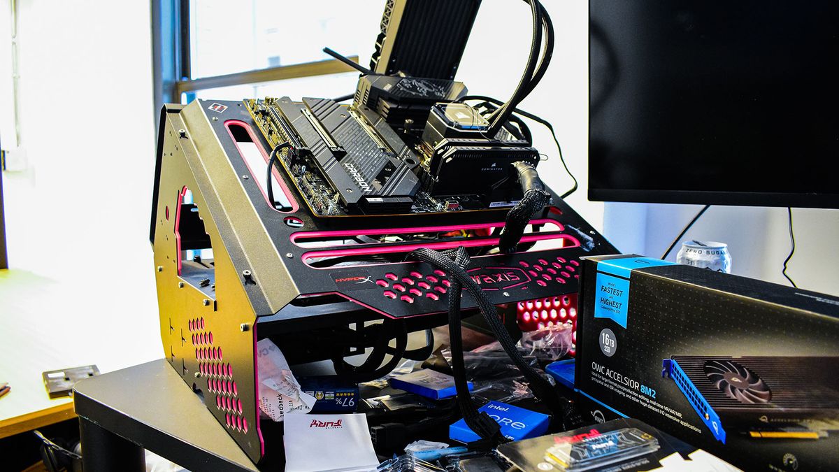 Test bench on a desk, with a bunch of junk surrounding it. 