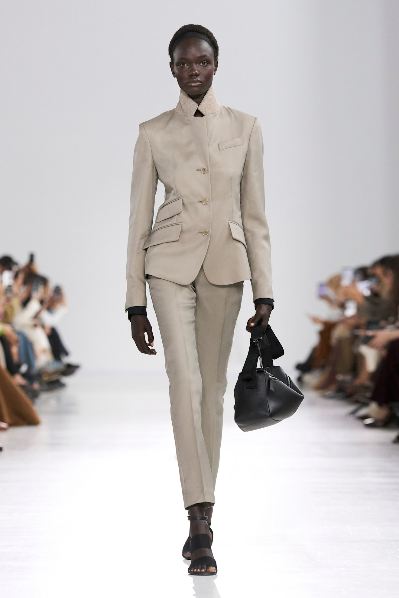 Model wears a single breasted blazer on the MaxMara runway.