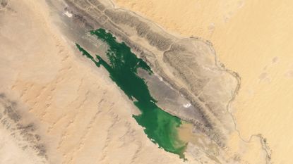 A satellite image showing a lake formed in a desert