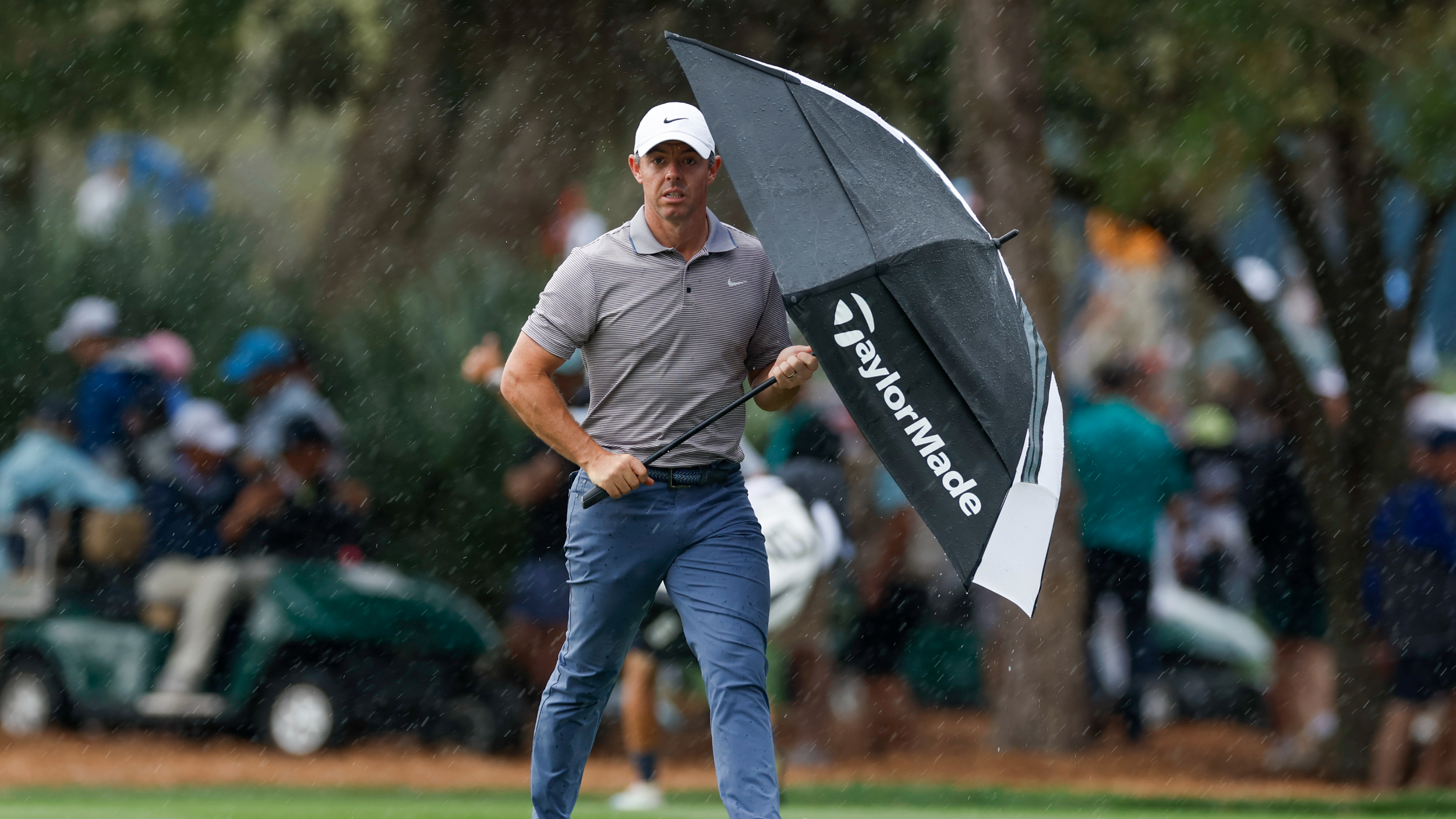 Rory McIlroy holding an umbrella at The Players Championship