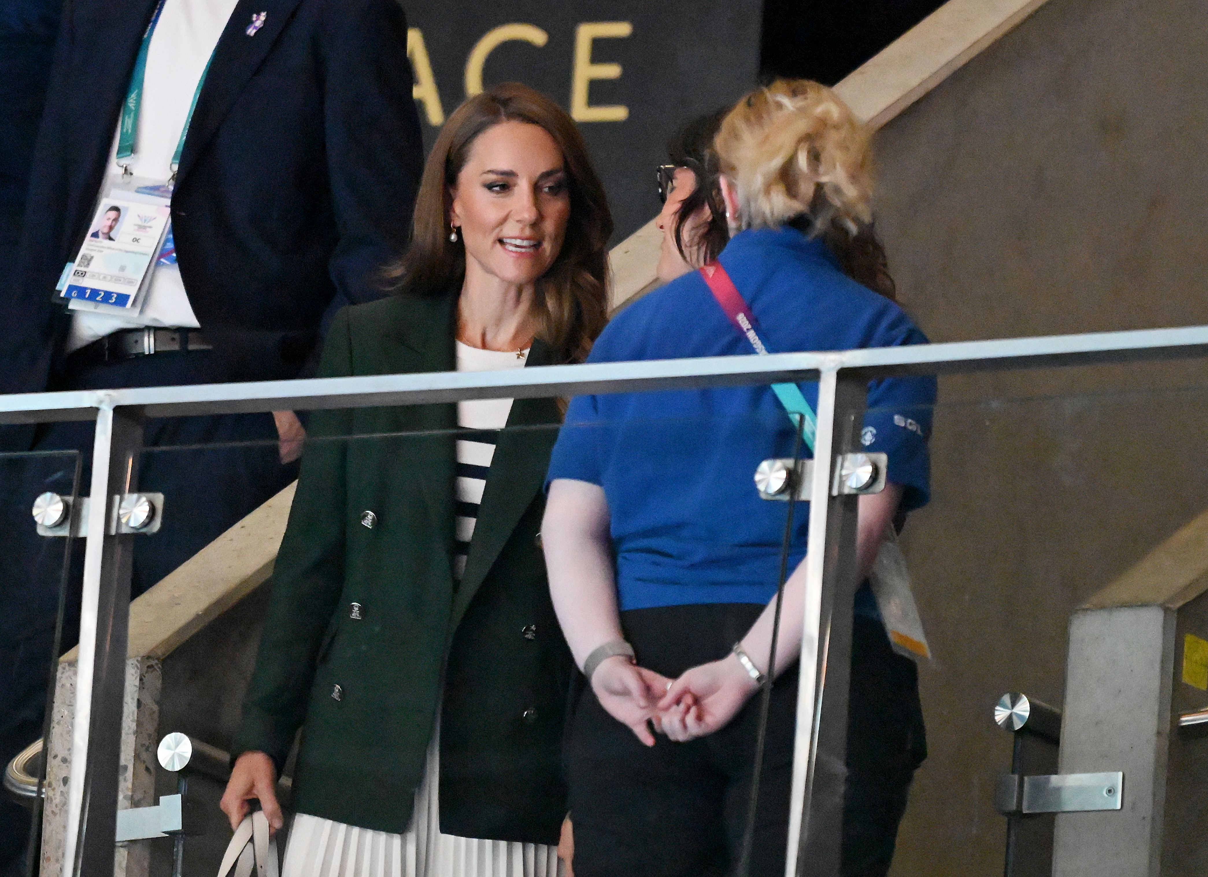 Princess Kate has long curly brown hair and is wearing a Breton striped sweater with a dark green Ralph Lauren blazer at the Commonwealth Games 2026