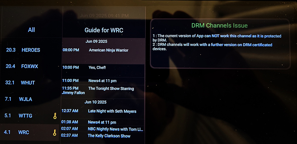 The GTMedia HDTV Mate ATSC 3.0 USB tuner displays program guide information on a cellphone screen.