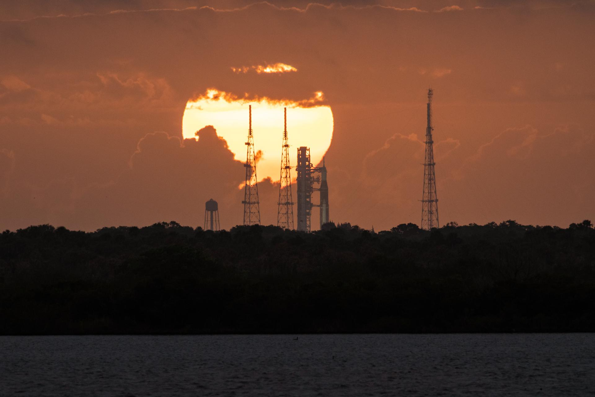 The sun rises behind NASA's Artemis 1 moon rocket at Pad 39B of the Kennedy Space Center in Cape Canaveral, Florida.