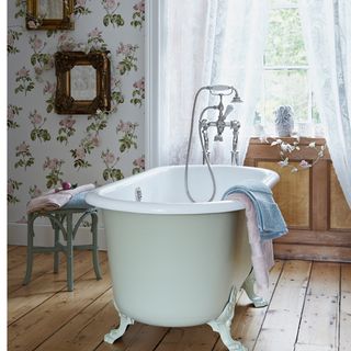 bathroom with bathtub and wallpaper wall and wooden floor