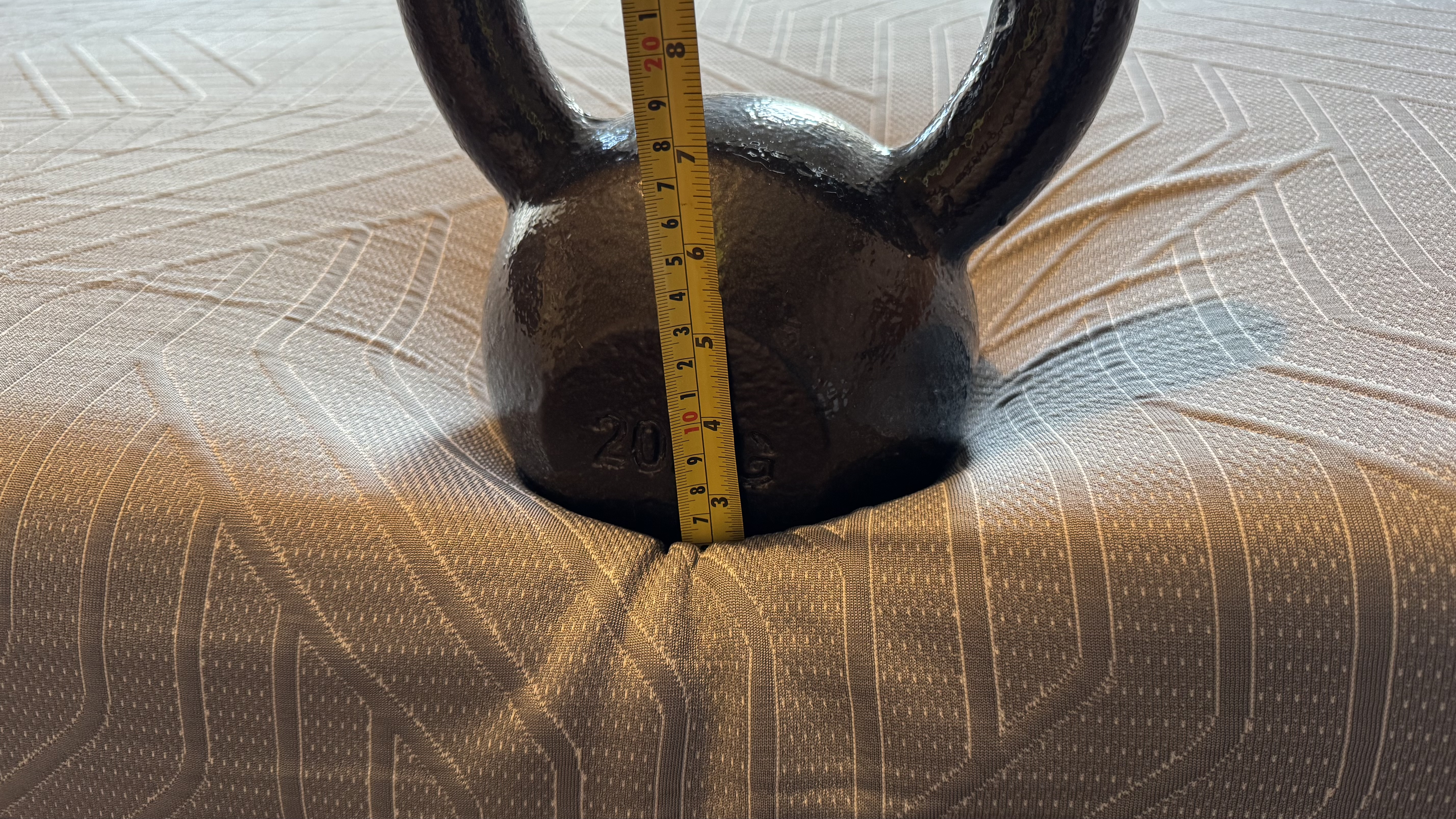 A heavy weight on the edge of the EGOHOME Hybrid mattress