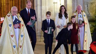 Princess Charlotte of Wales has her candle blown out by Prince Louis of Wales at the "Together At Christmas" Carol Service" at Westminster Abbey in London on December 8, 2023