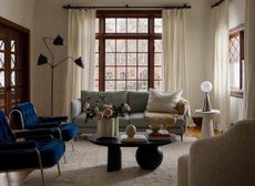 A living room with boucle and velvet sofas and chairs