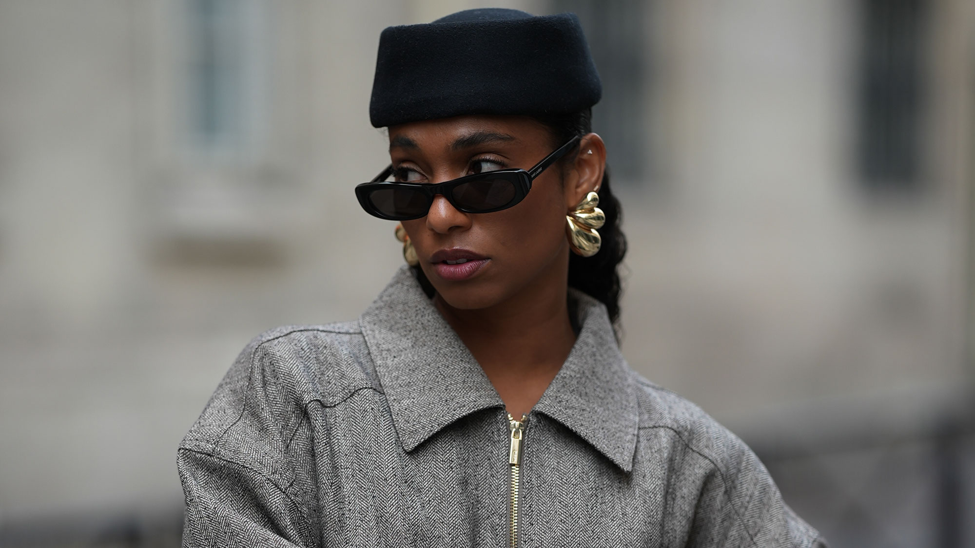 a woman wears a pillbox hat