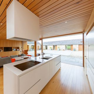 wooden kitchen area with white worktop