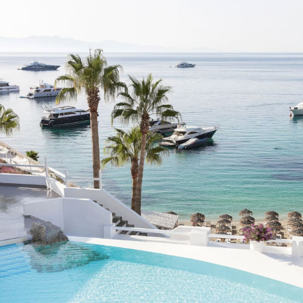 Image of pool overlooking sea view with small boats