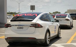 NASA astronauts Bob Behnken and Doug Hurley walk out of NASA's Astronaut Crew Quarters and take a Tesla Model X to Launch Pad 39A during a dry-run test of their SpaceX Crew Dragon Demo-2 flight on May 23, 2020 at the Kennedy Space Center in Florida.