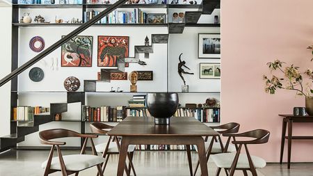 living space with large dining table and stairs