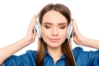 A woman listens to music through her headphones