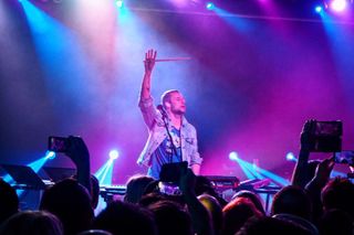 Fans holding camera phones aloft during a gig by The Midnight in London, England