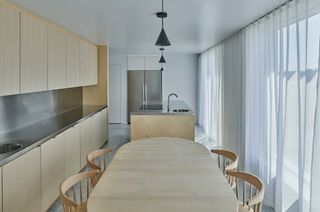 Pale wood dining table in kitchen at Simonsson House, Sweden, by Claesson Koivisto Rune