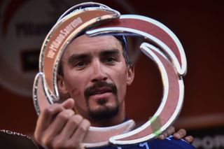 Julian Alaphilippe takes a look at his new trophy