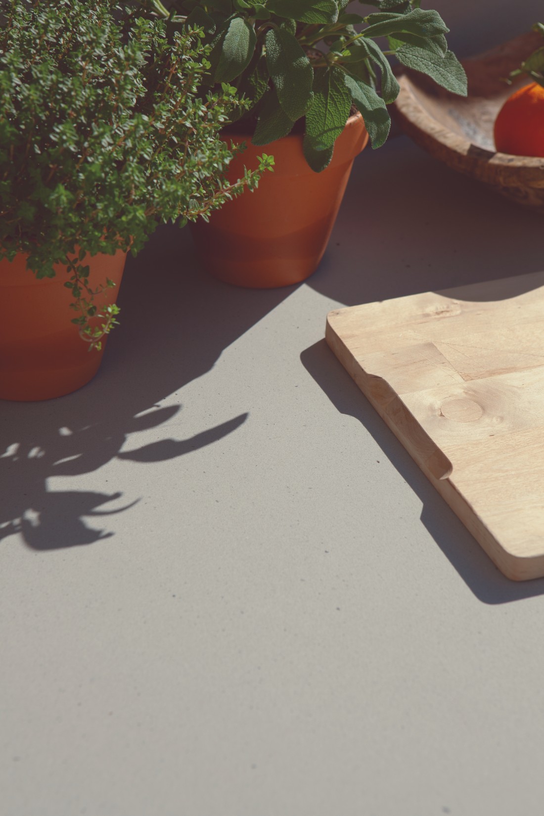 Outdoor kitchen worktop with herbs and cooking essentials