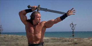 Arnold Schwarzenegger wielding sword as Conan the Barbarian