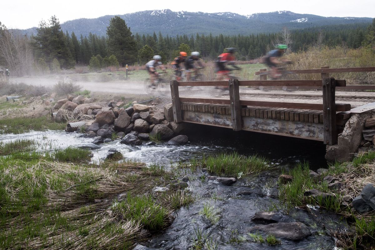 Riders cross a wooden bridge on the dirt roads of the Sagan Fondo on May 5, 2018