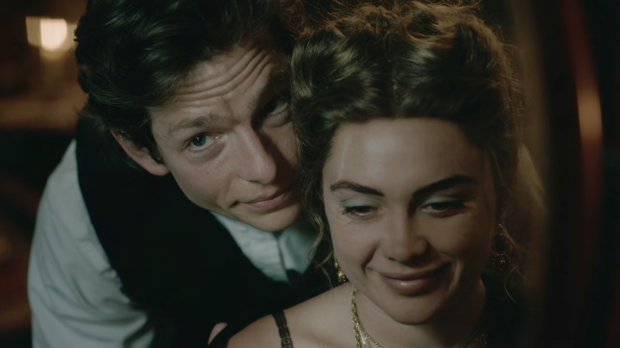 Mike Faist in a clean dress shirt and vest as Charles trask, Florence Pugh with strapped black dress in East of Eden (2026).