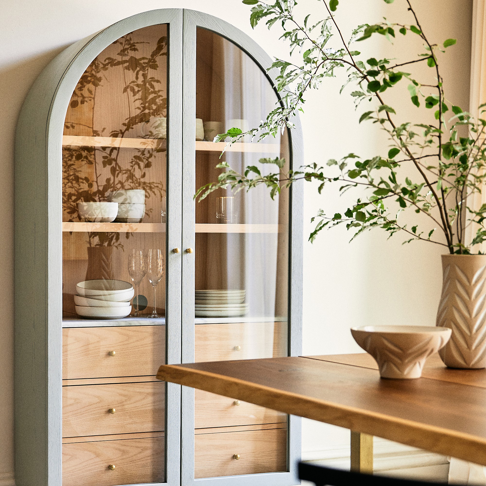 Anthropologie Fern Ash Wood Storage Cabinet in a dining room displaying tableware