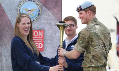 Prince Harry helps light the cauldron as he attends the Opening Ceremony of the Warrior Games in Colorado Springs.