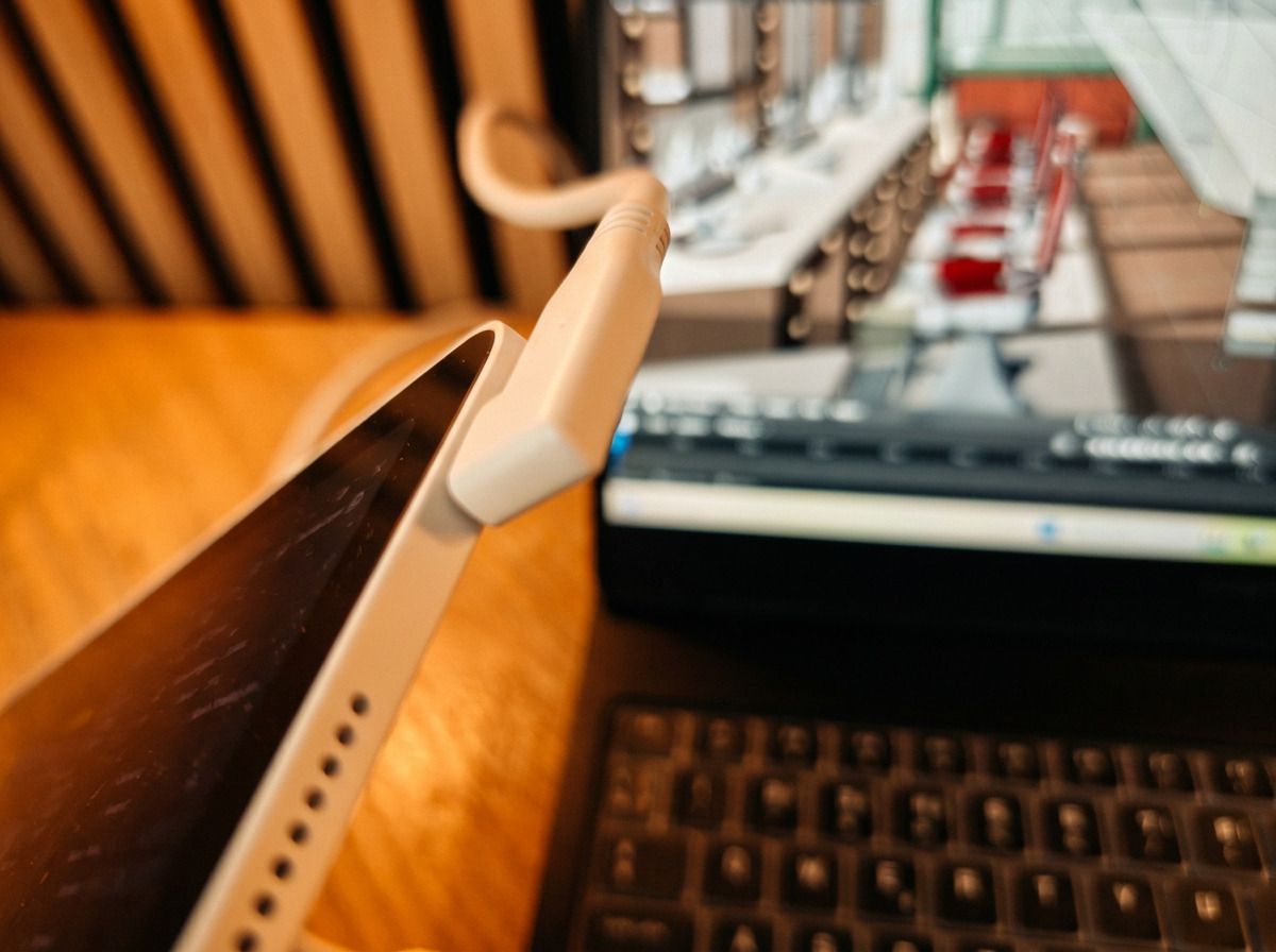 Photos of a white drawing tablet on a wooden table, the XPPen Magic Pro 13