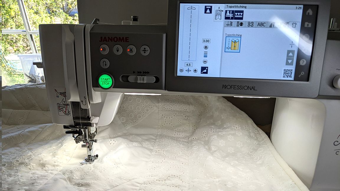 Janome Continental M7 review, a sewing machine on a table with a quilt