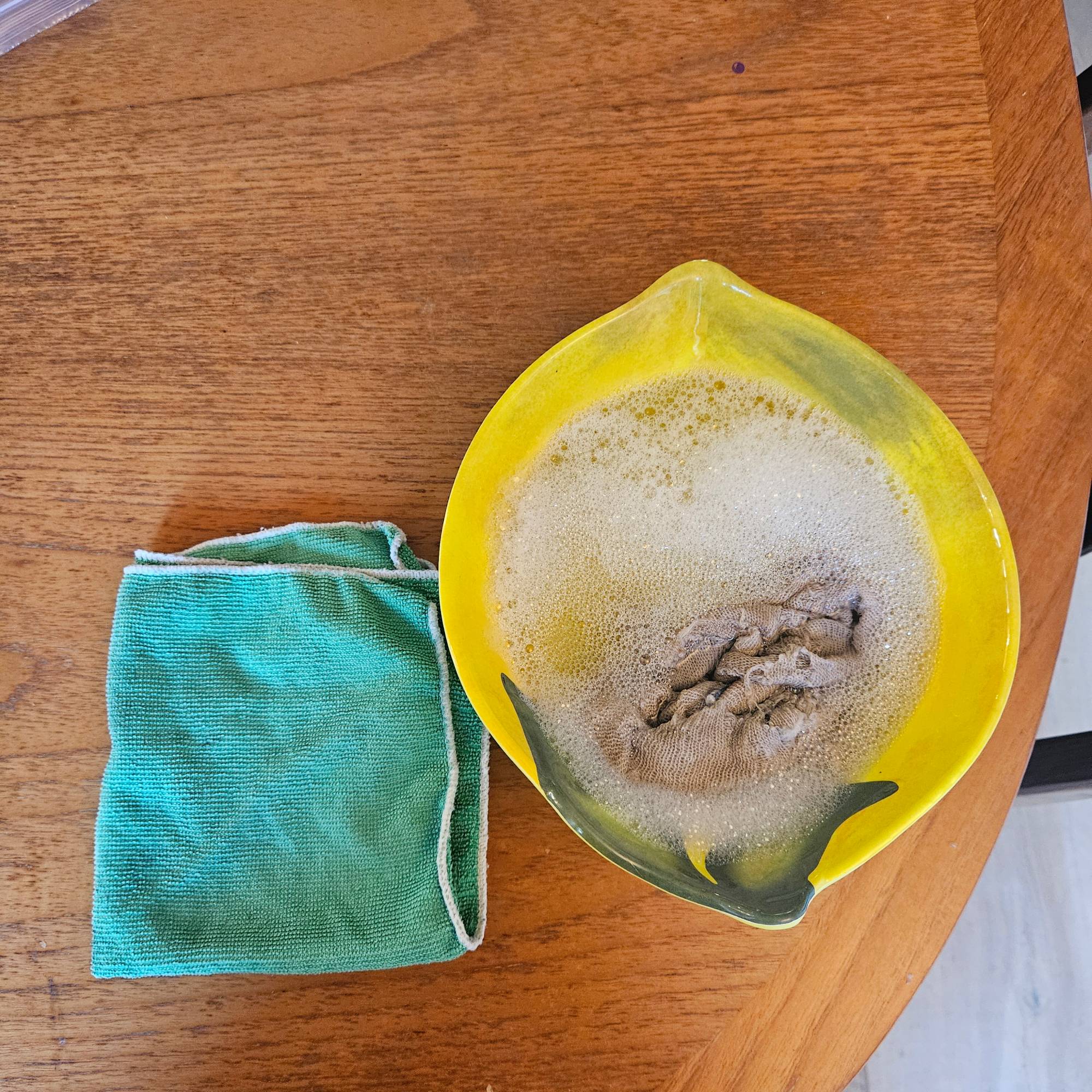 microfibre cloth and lemon shaped bowl filled with soapy water