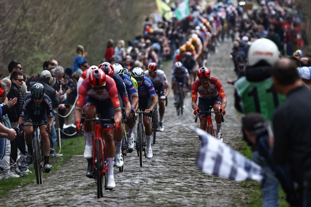 The pack of riders cycles over the Trouee dArenberg cobblestone sector during the 120th edition of the ParisRoubaix oneday classic cycling race between Compiegne and Roubaix northern France on April 9 2023 Photo by AnneChristine POUJOULAT AFP Photo by ANNECHRISTINE POUJOULATAFP via Getty Images